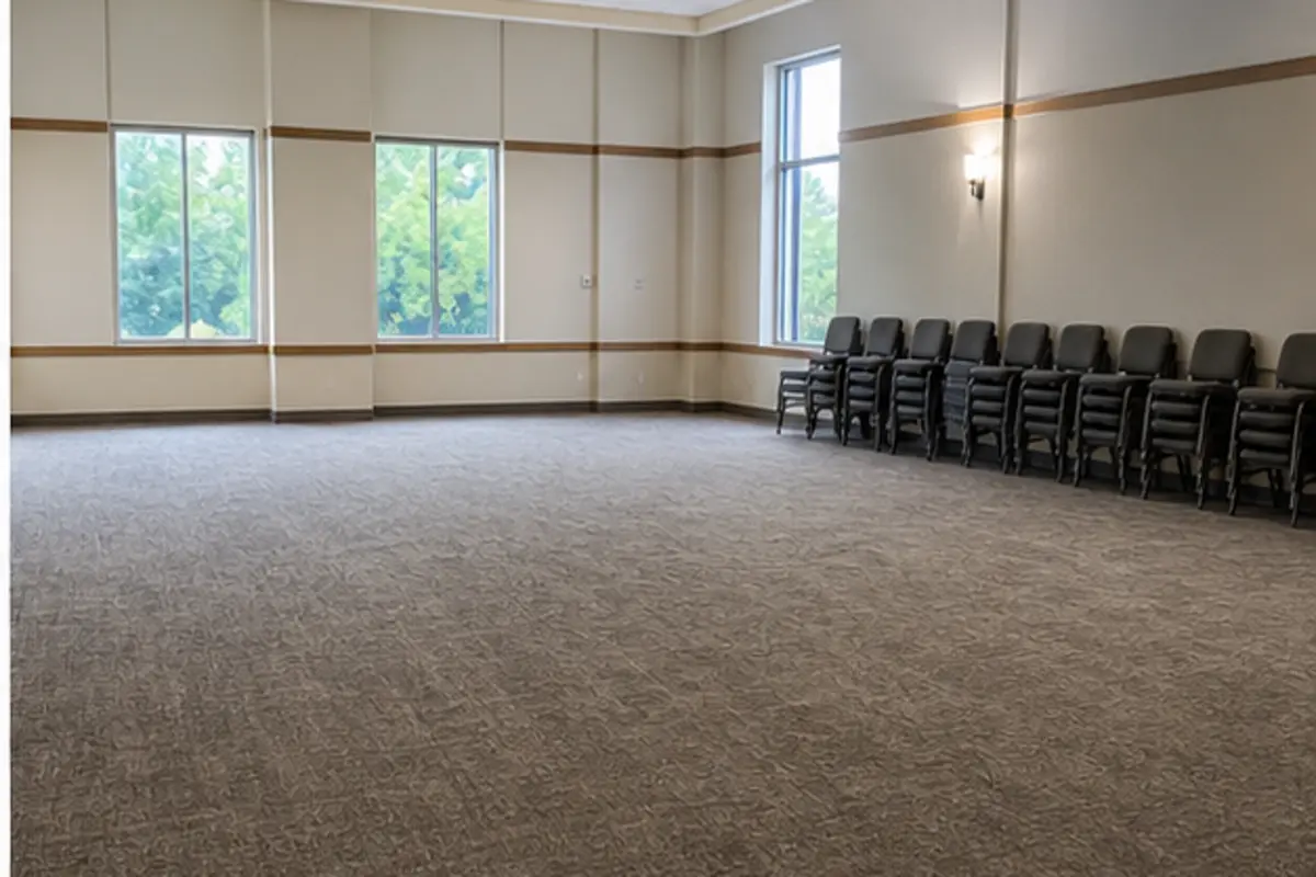 Quiet church lobby carpet drying with clear walkways and stacked chairs